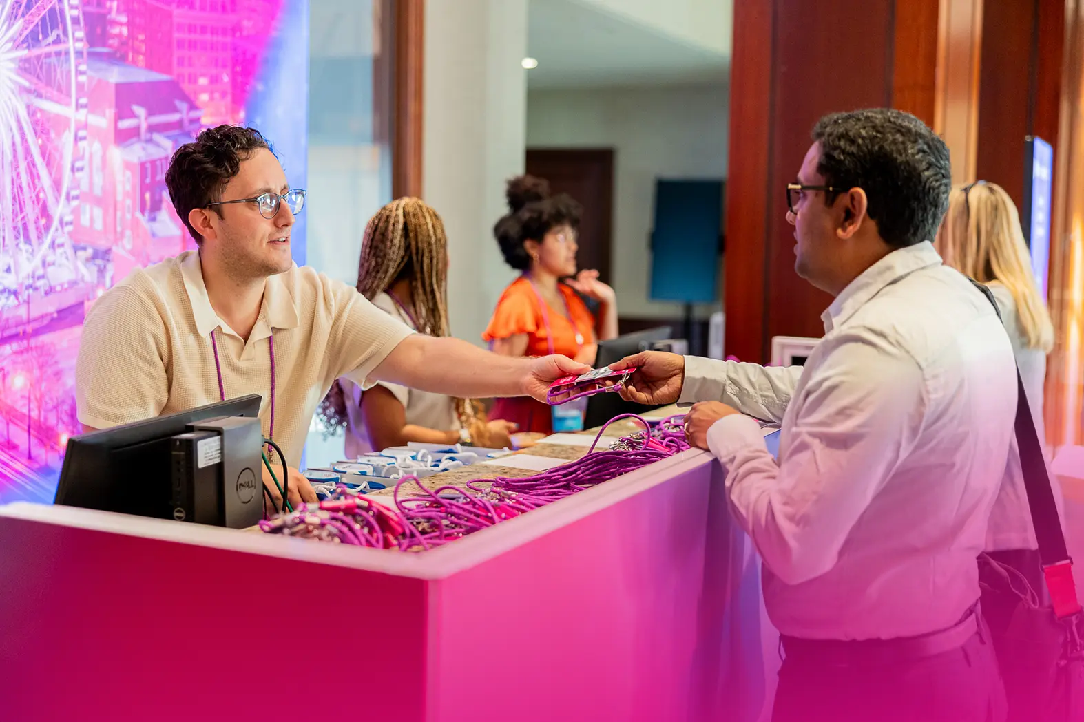 eventguru-b2b-event-onference-attendee-picking-up-a-name-badge.webp